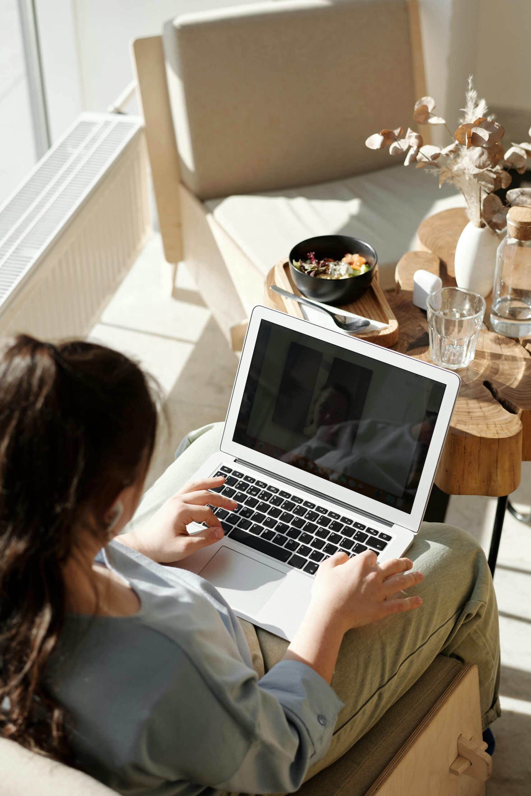 Person working on a MacBook to update DNS settings for a seamless DNS transfer to Showit, ensuring a smooth website transition.