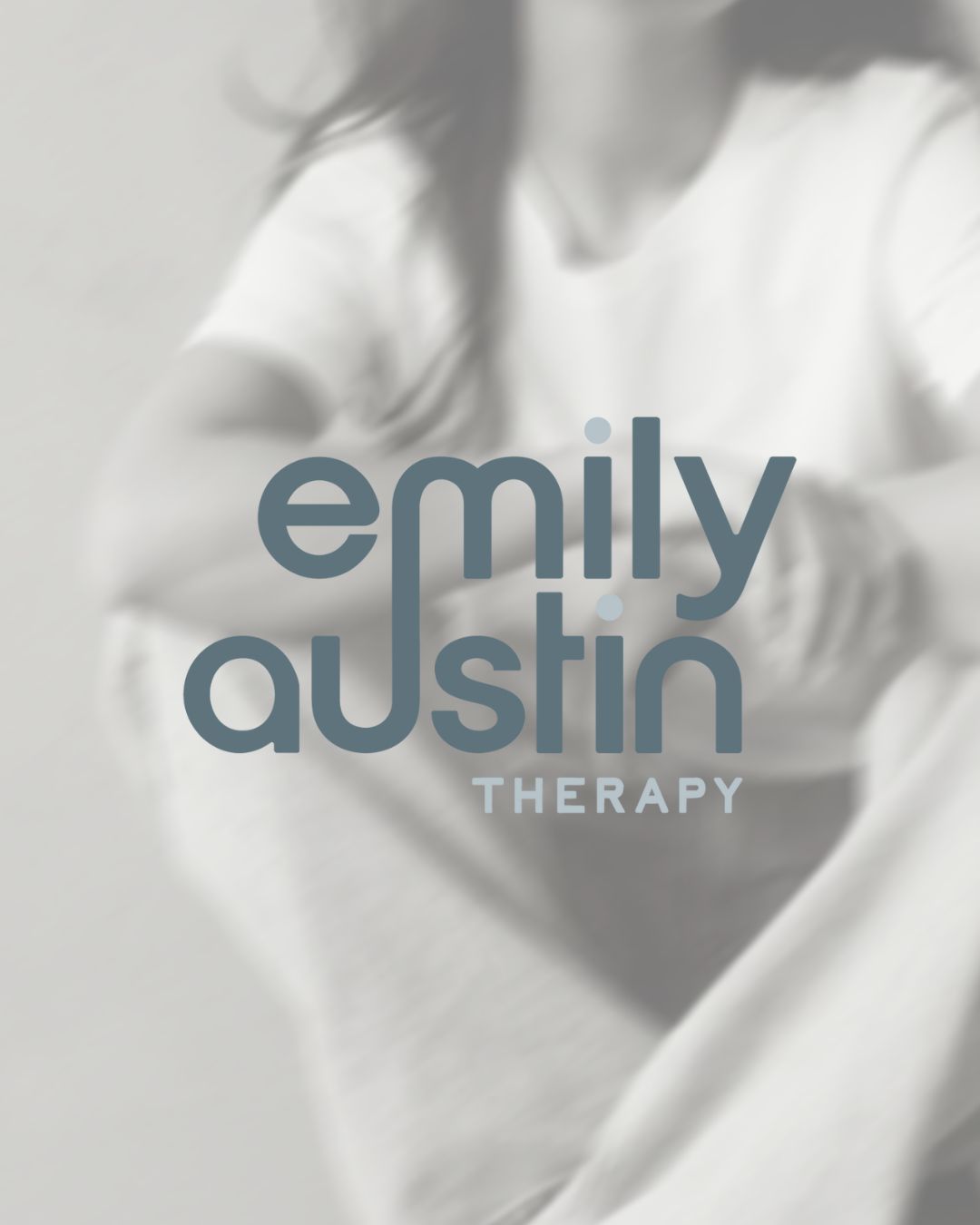 Grayscale image of a person overlaid with blue-gray text reading “Emily Austin Therapy,” conveying comfort and care.