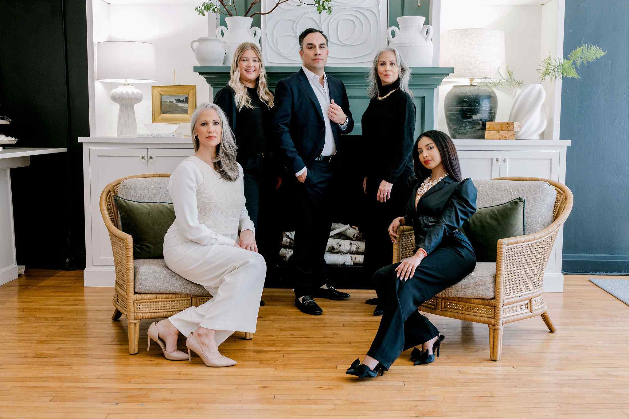 group of professionals sitting down for a company photoshoot.