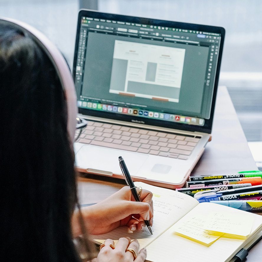 woman working through her new year website audit checklist on her laptop