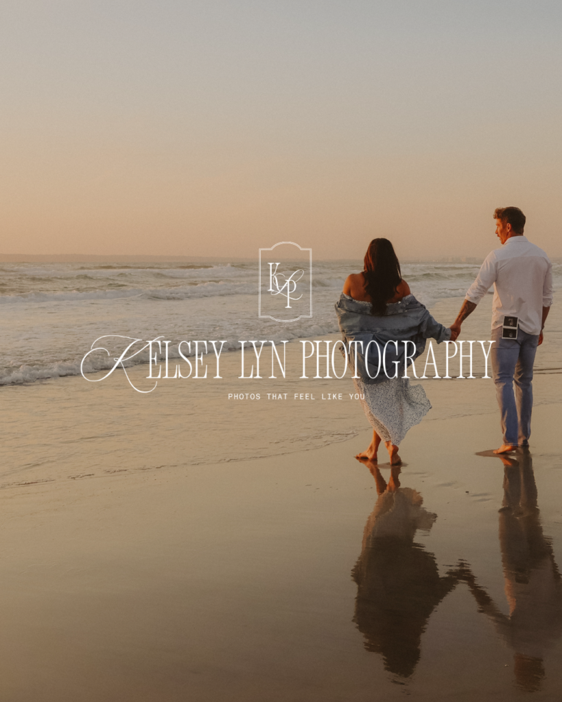 A couple stands hand in hand at the water’s edge at sunset, reflected in wet sand; “Kelsey Lynn Photography” overlays the serene beach scene.