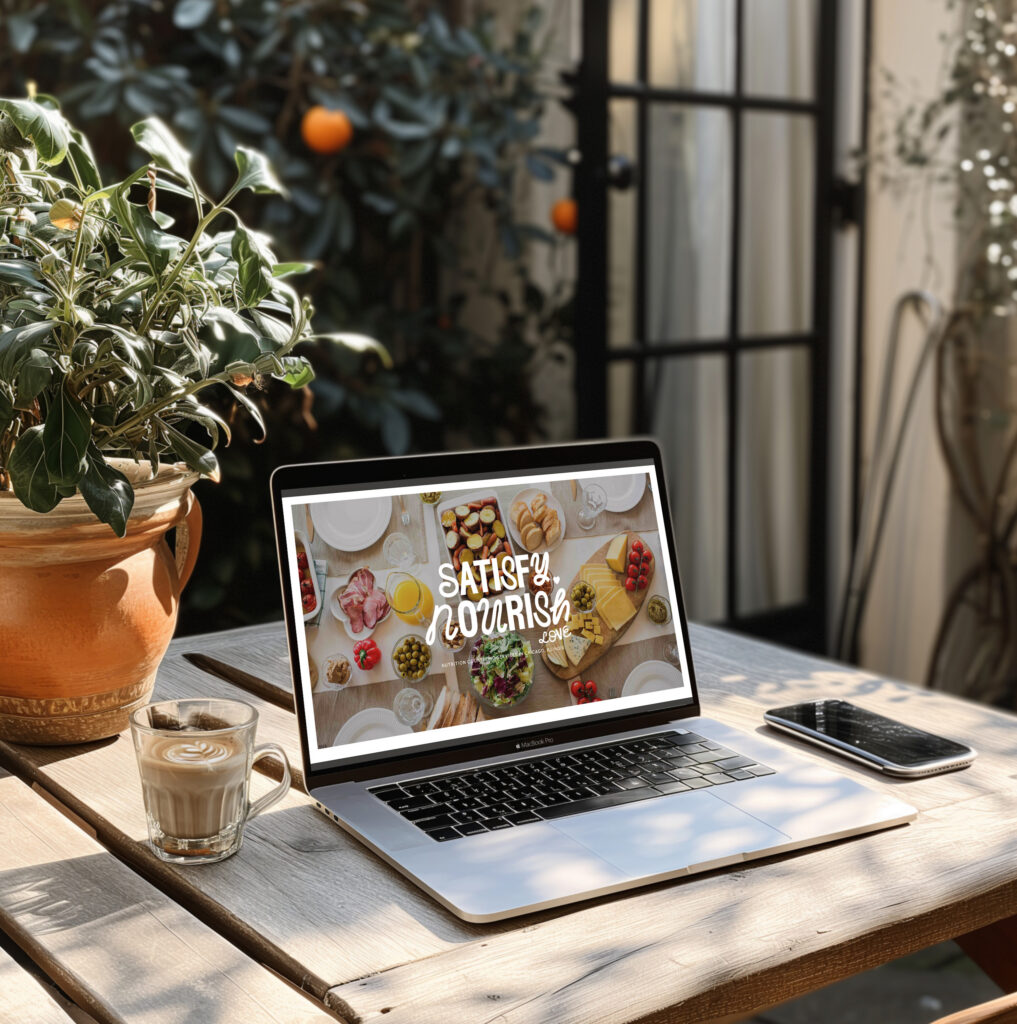 Sunlit patio workspace with laptop showing “Satisfy Your Curiosity,” coffee, smartphone, and potted plants creating a warm, inviting mood.