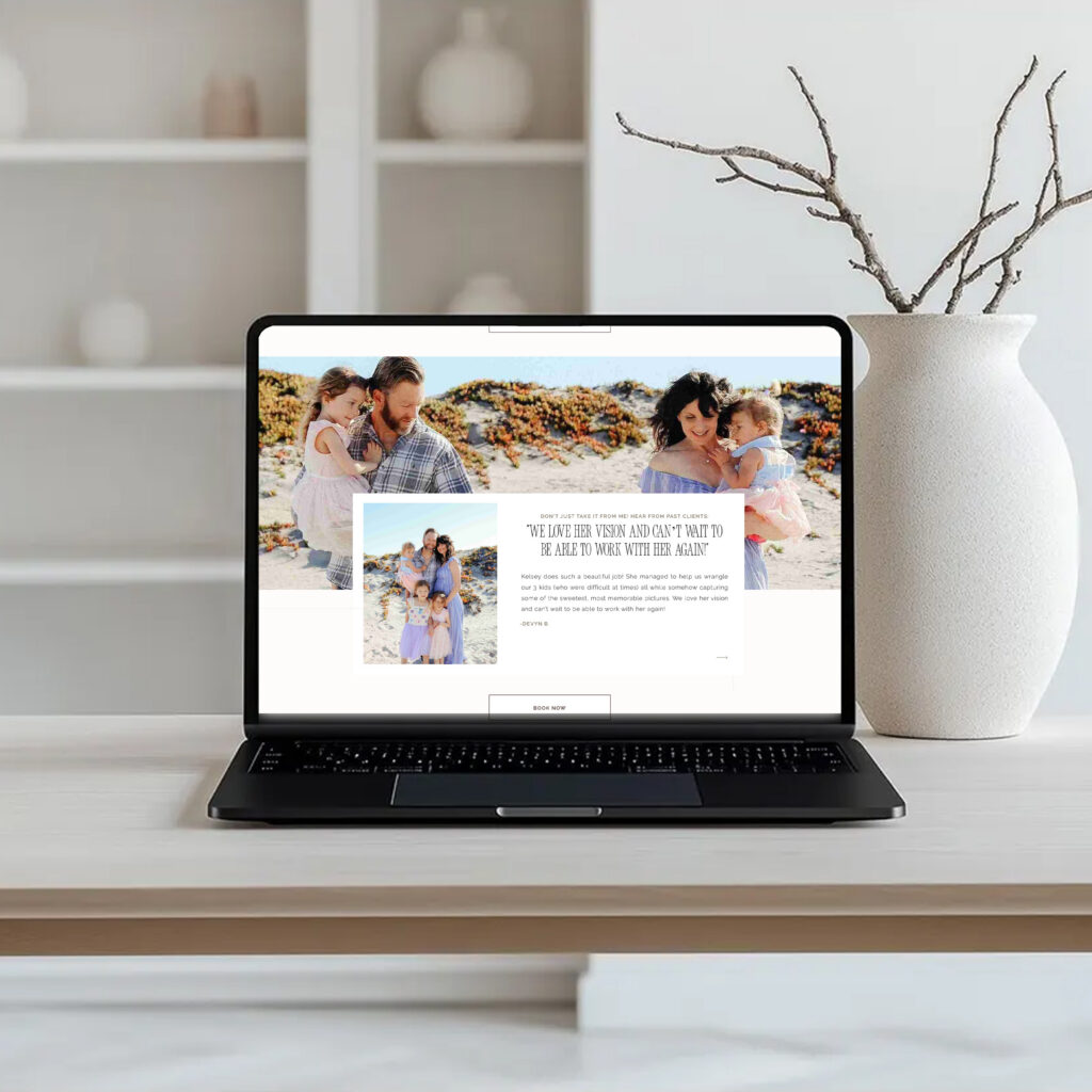 A laptop on a tidy desk displays a family photography website, with a white vase and bare branches behind it, creating a calm, professional tone.
