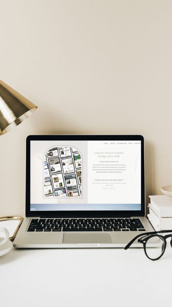 A laptop, a lamp, and a coffee cup arranged neatly on a wooden desk.