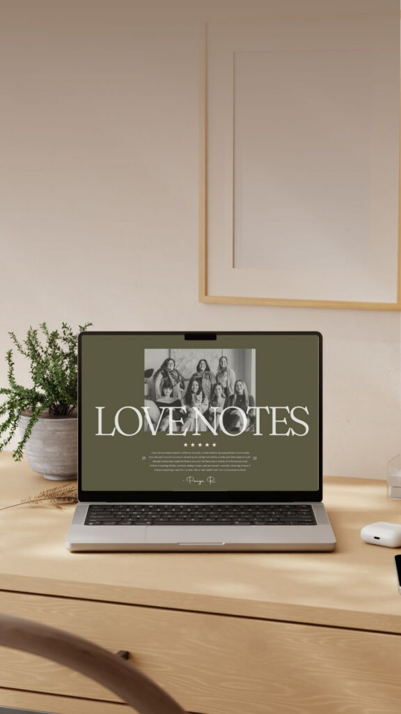 Laptop displaying a “LOVE NOTES” album cover with vintage group photo, on a wooden desk beside a potted plant in a warm, minimalist room.