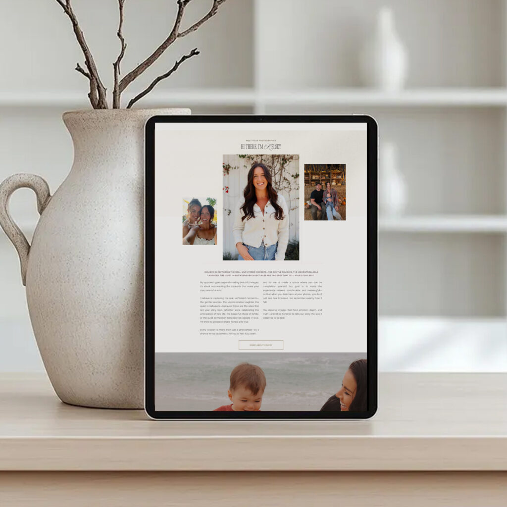A tablet displays a family profile page with a woman’s portrait and smaller photos, beside a vase of bare branches on a shelf; calm, minimalist setting.