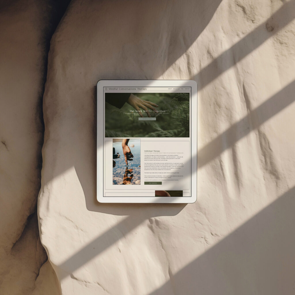 Tablet displaying a nature and outdoor adventure webpage mounted on a textured beige wall, with warm sunlight and diagonal shadows creating a calm mood.