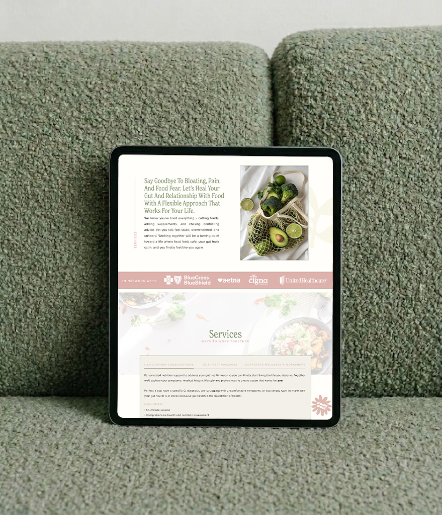 Tablet displaying a wellness website with healthy food photos, recipes, and services, propped against a textured green sofa in a calm setting.
