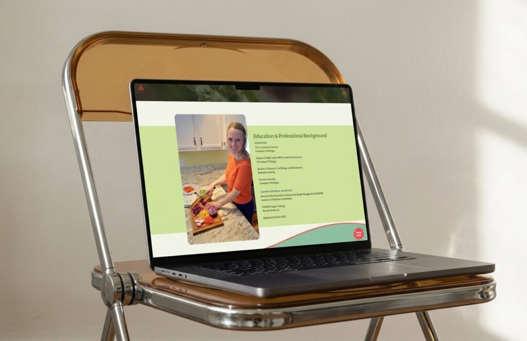 Laptop on a vintage chrome-and-wood folding tray displays a presentation with a smiling woman cooking, suggesting an educational, professional profile.