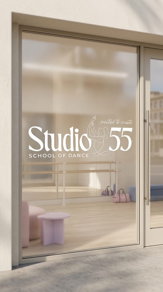 Glass dance studio door with “Studio 55 School of Dance” lettering, revealing a bright ballet room, barre, mirrors, and pastel furnishings.