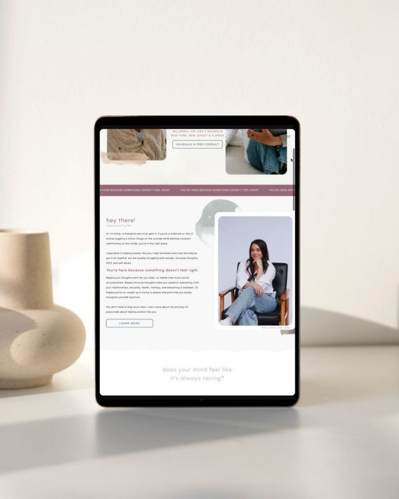 Tablet displaying a welcoming wellness webpage with text, a seated smiling woman, and calming photos, set on a bright minimalist desk.