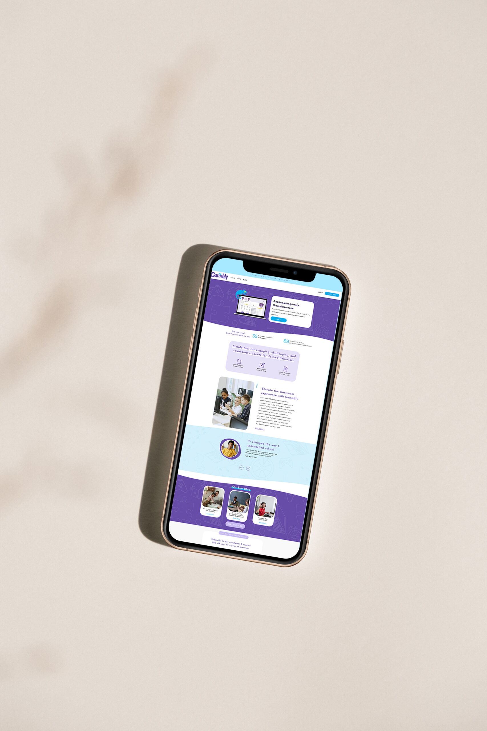 A smartphone lies at an angle on a soft beige surface, displaying a bright purple-and-white ed tech website with text and thumbnail images; the scene feels calm and minimal.